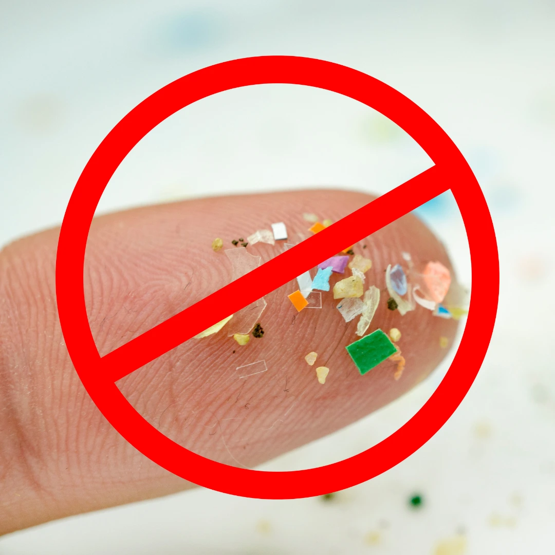 Microplastics on a fingertip with a prohibition sign